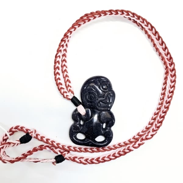 SIC2003HT Blue sunstone Hei Tiki on red/pink woven strand